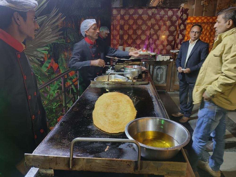 Chef preparing food live at a counter for guests