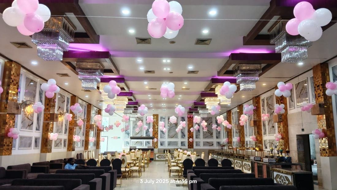 Banquet hall corridor with chandeliers and pastel balloon clusters